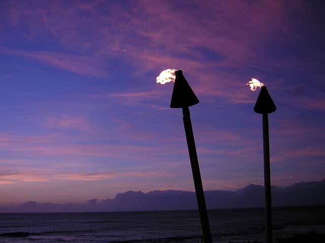 Romantic tiki torches blazing at sunset