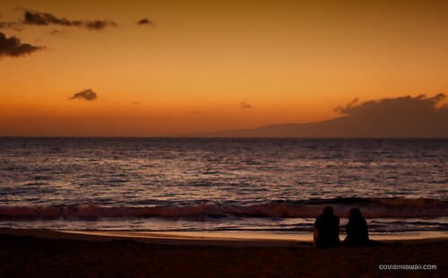 couple enjoy the post sunset sky at wailea beach