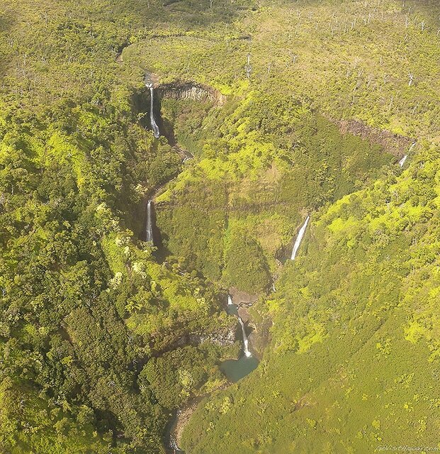 A view from a helicopter of remote Kauai waterfalls.
